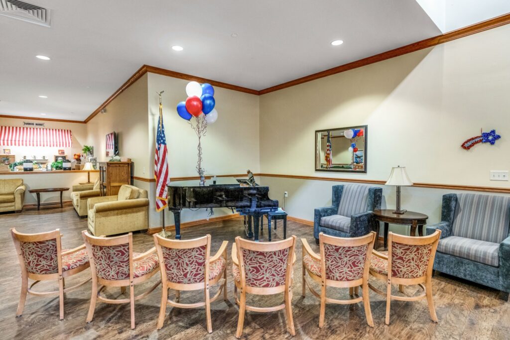 Chairs are arranged for a performance in front of a piano in the lounge at Town Village Sterling Heights, a senior living community near Detroit.
