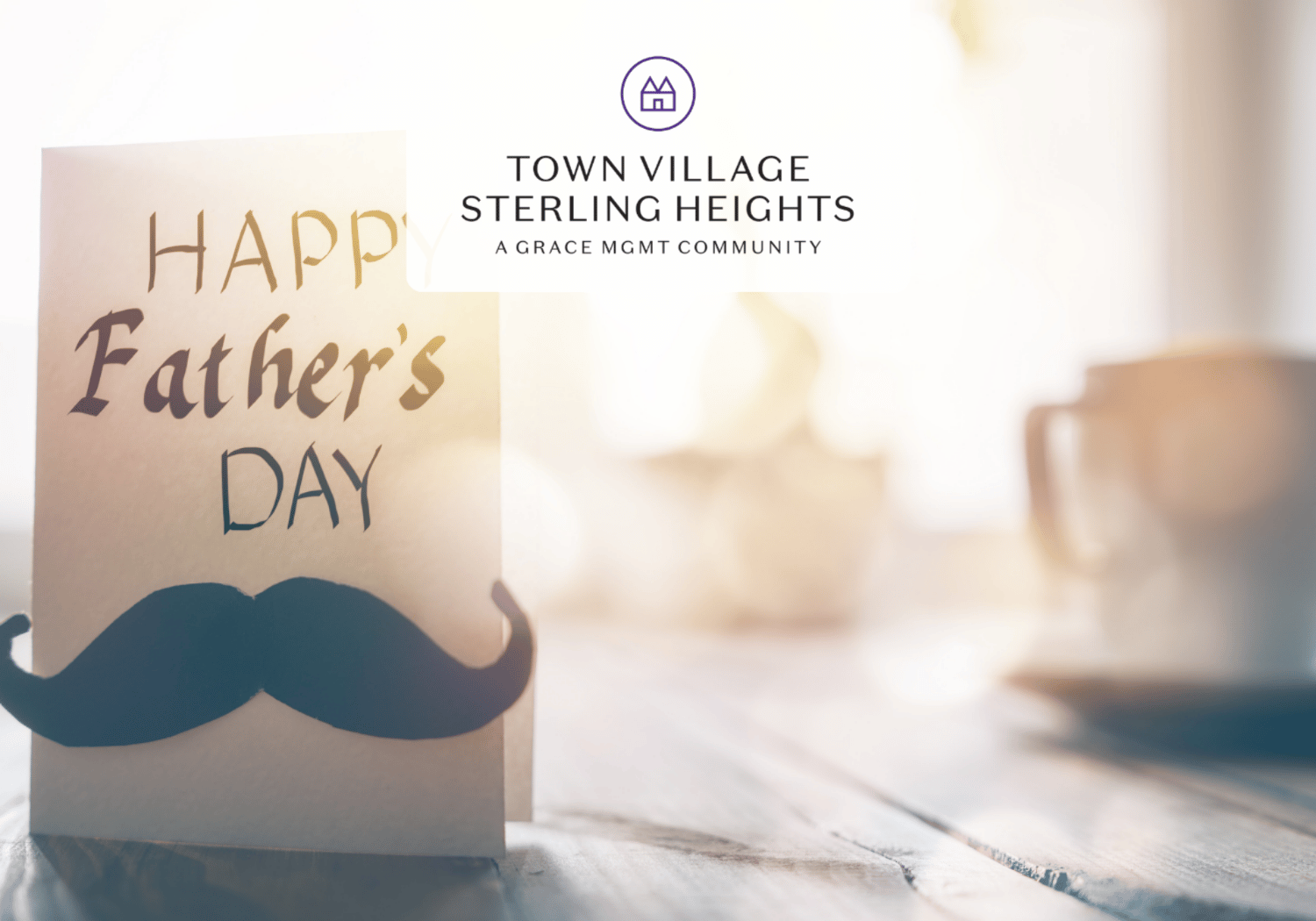 Father's Day greeting card with a mustache cutout on a wooden table and a blurred mug in the bright background.